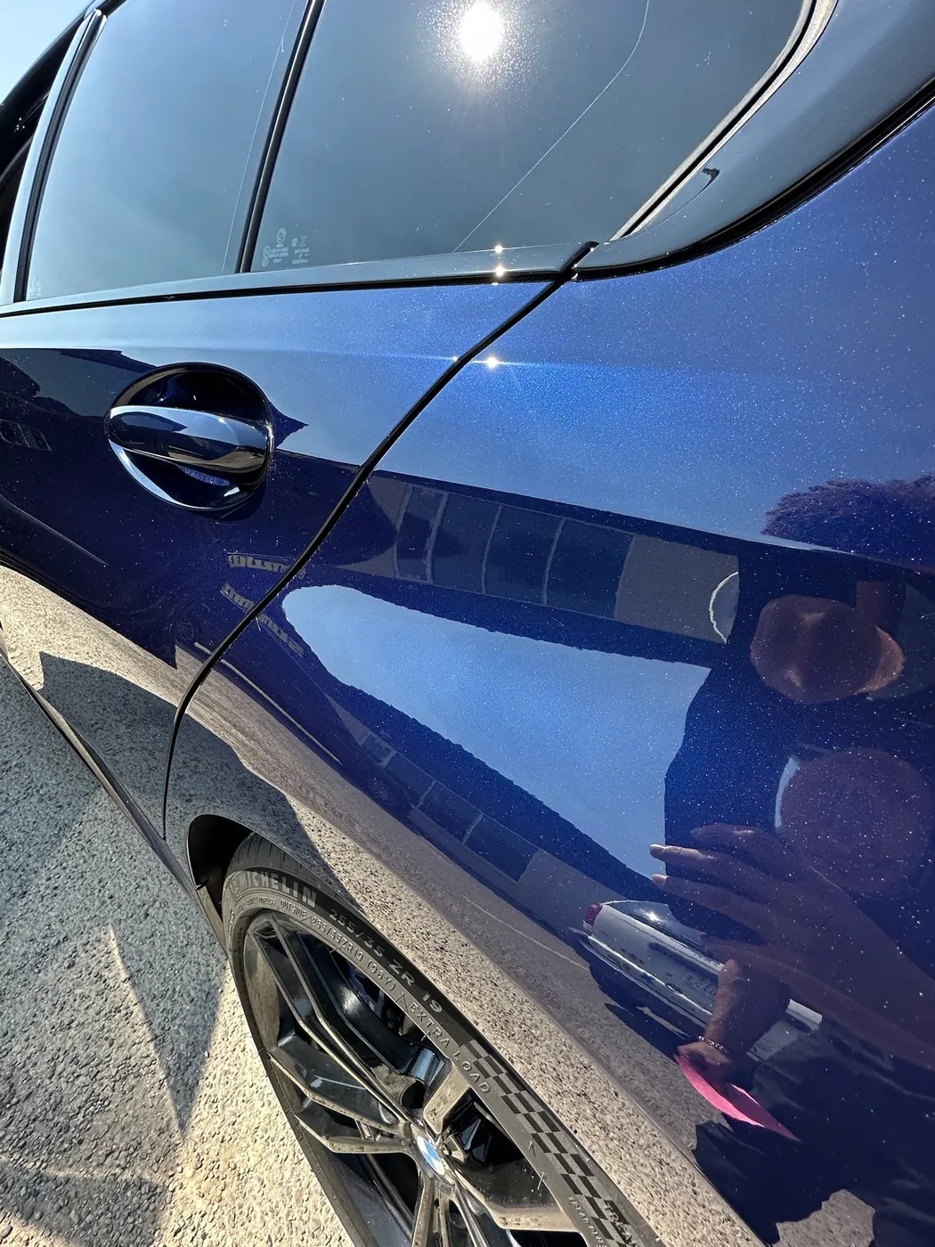 Blue BMW M340i door reflecting like a mirror after correction and coating