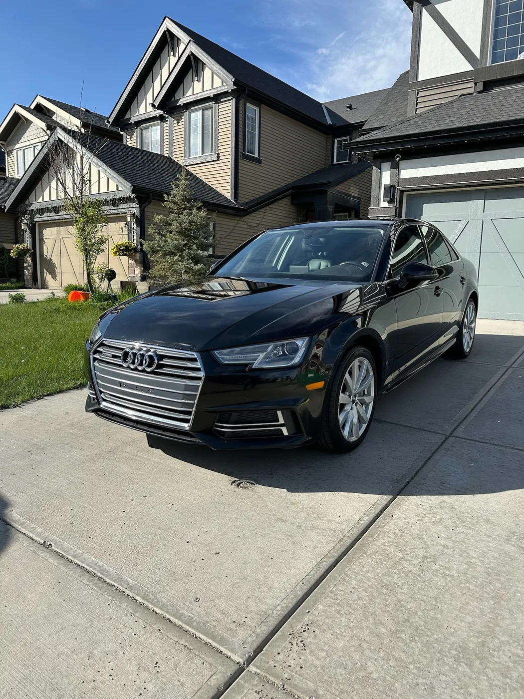 Black Audi A4 in a Calgary driveway after a complete detail