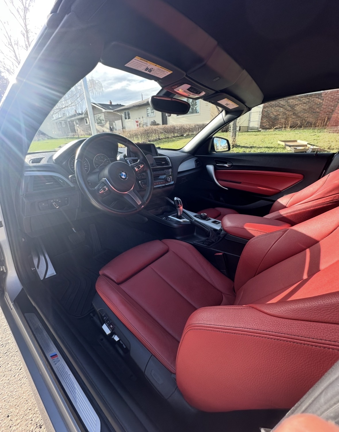 BMW interior with red leather seats, steering wheel and dash after deep clean