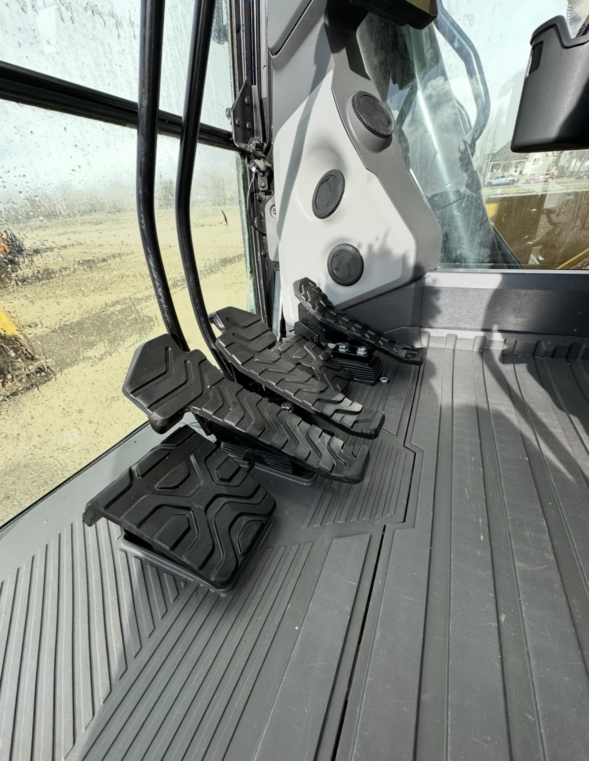 Spotless CAT excavator floor pedals and cab interior after detail