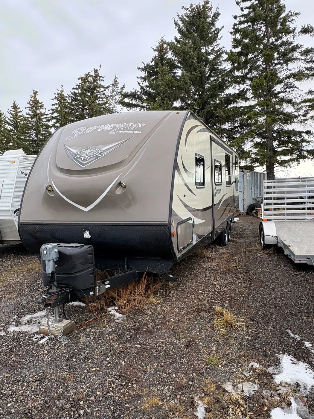 Travel trailer parked at a Calgary-area storage lot after a fall wash and seal